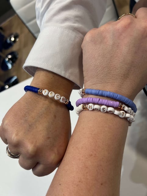 Two hands showing swifty style bracelets on each