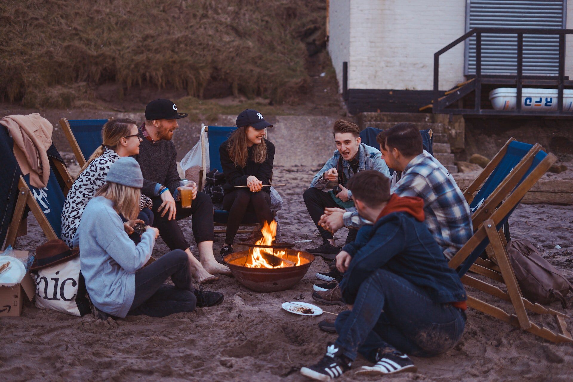 group of young people around a fire