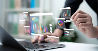 Photo of a digital dashboard with holographic graphs and charts on laptop representing hotel dynamic pricing analytics.