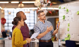 Photo of hotel managers discussing KPIs and planning a strategy.