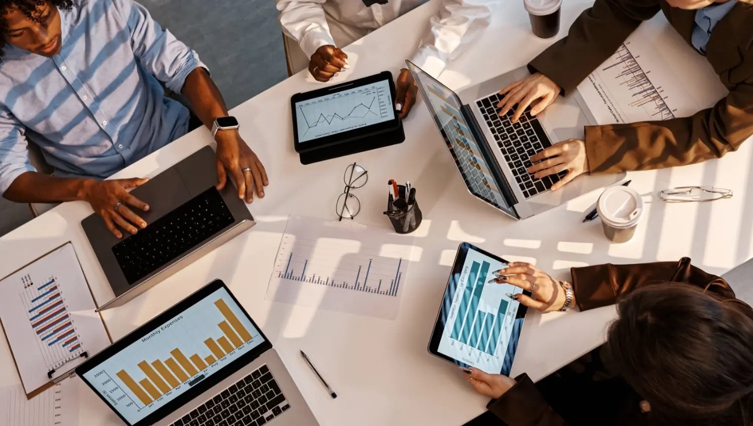 Hotel managers reviewing metrics in a strategy planning meeting. 