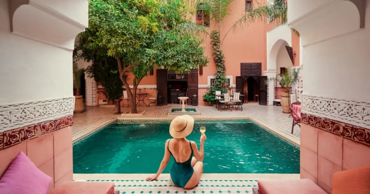 Photo of a woman in a lush hotel environment. 