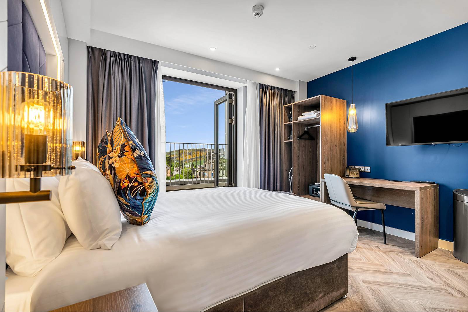 hotel bedroom with blue wall and window