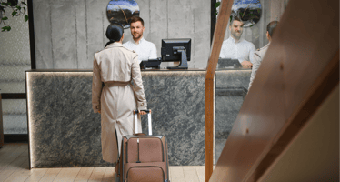 Woman checking in at hotel with RMS