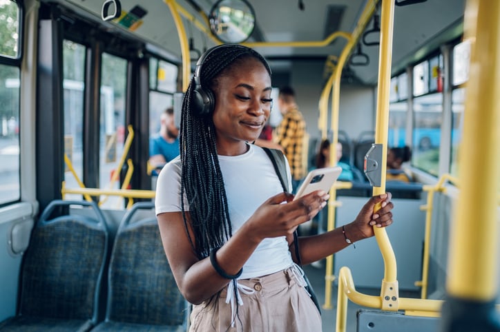 Young hotel worker listening to a podcast on her way to work.