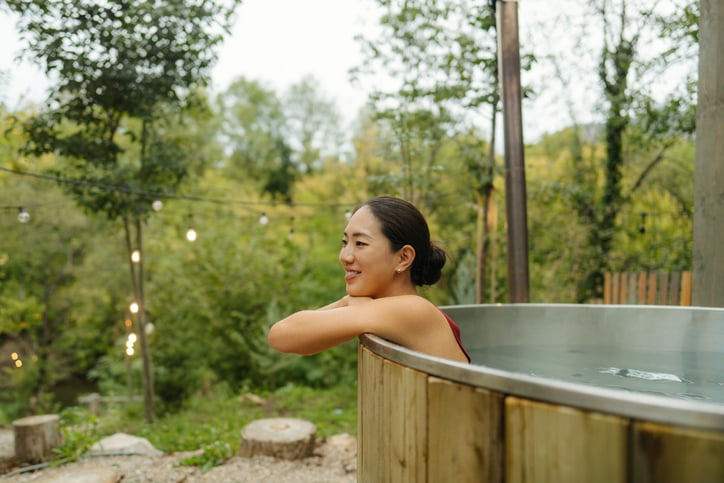 Photo of a woman relaxing in a hot tub.