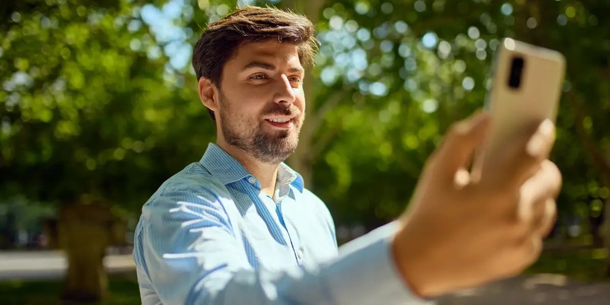 Staff member in a holiday park using a mobile device.