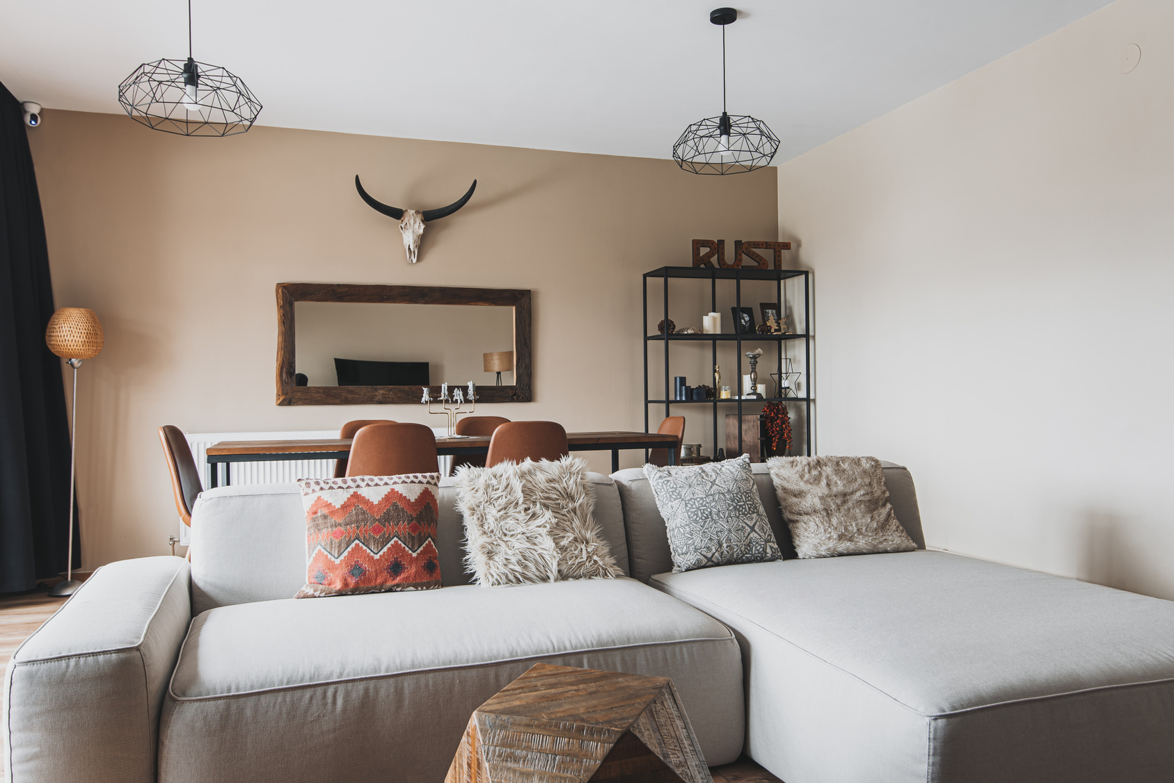 Couch, dining table, mirror and deer head in a motel