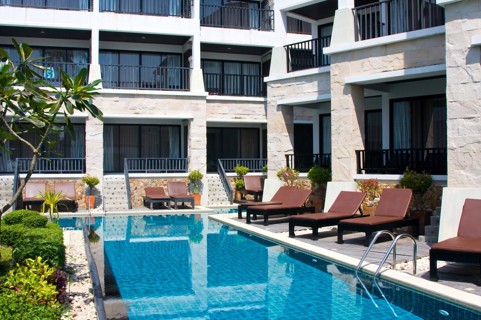 Loungers around a swimming pool at a motel