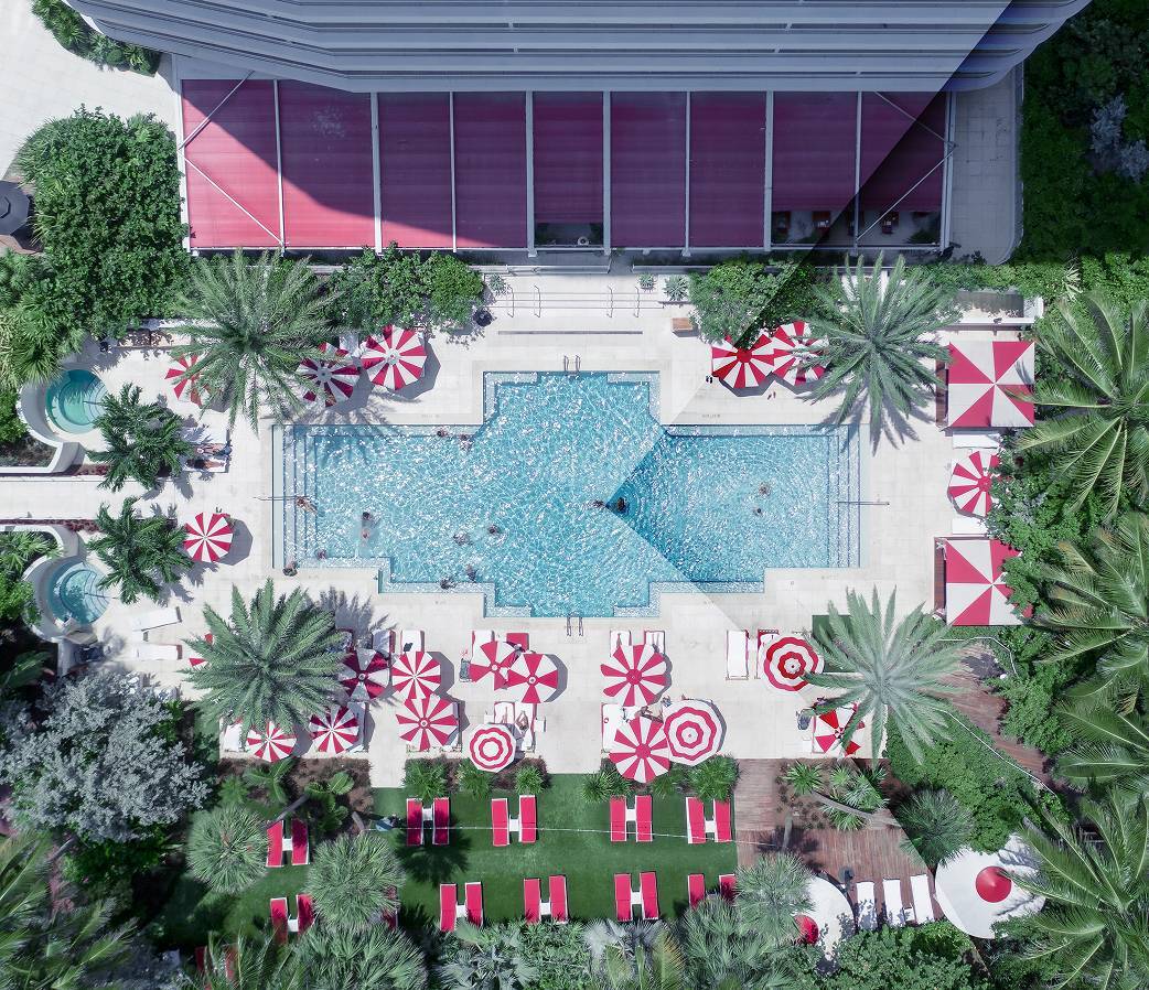 Birds eye view of pool with red chairs
