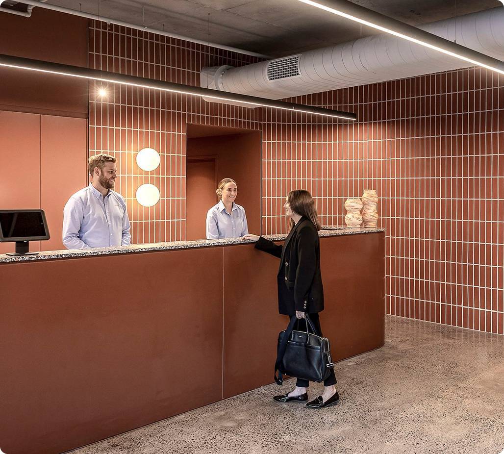 Smartly dressed woman standing at reception desk