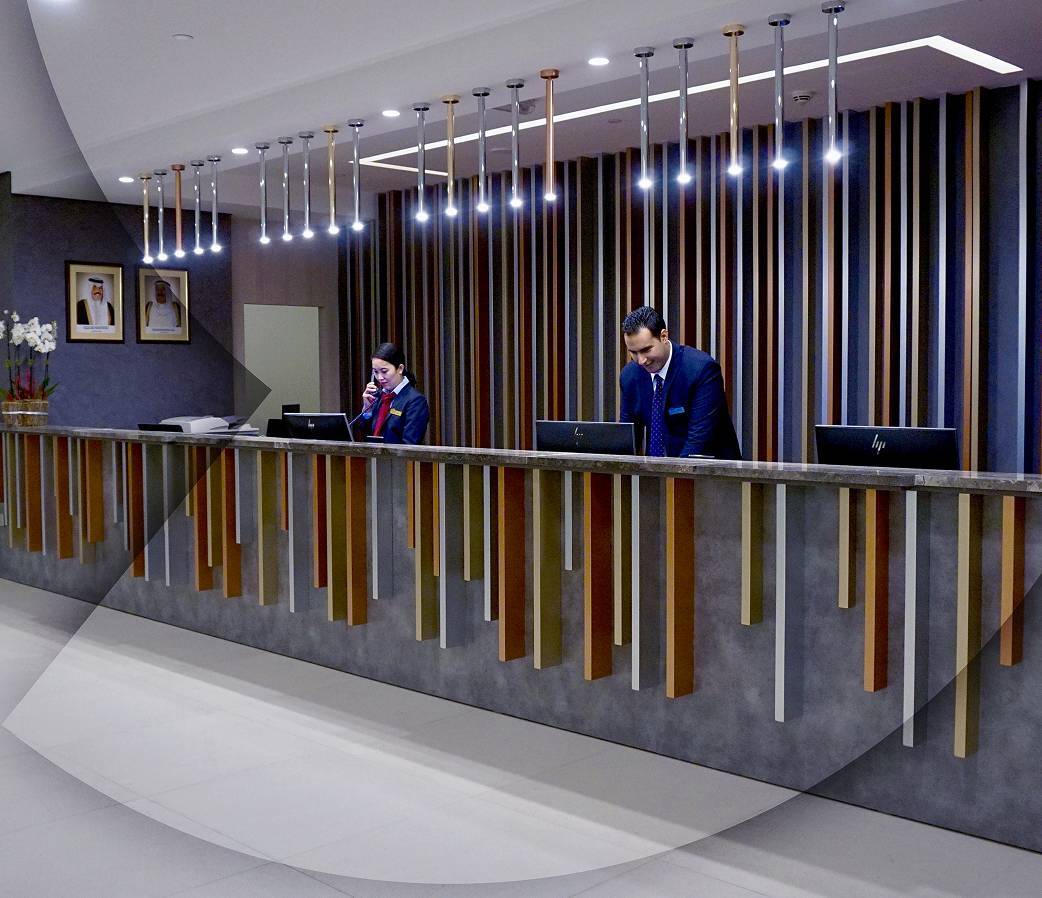 Front desk with two people in blue suits