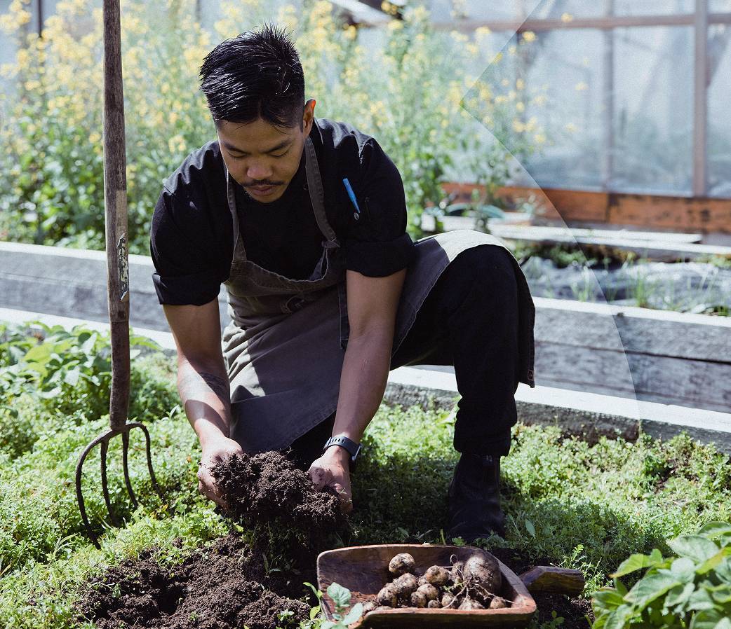 Man with apron doing work in allotment