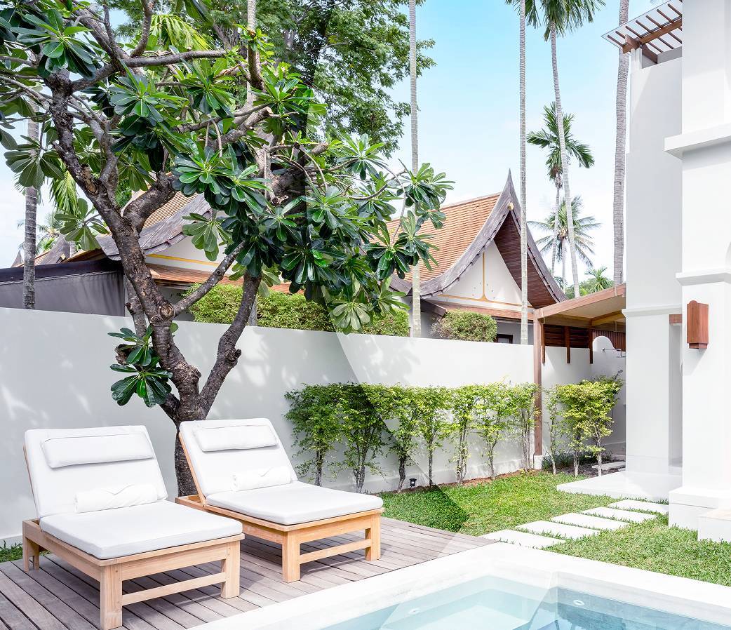 Two deck chairs by pool