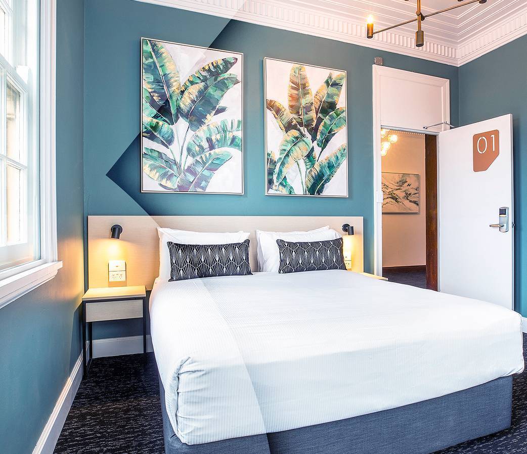 Hotel room with double bed and blue walls