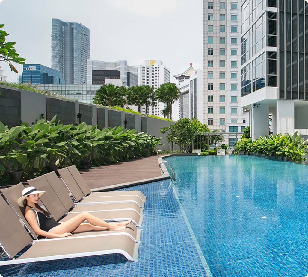 Woman lounging by pool