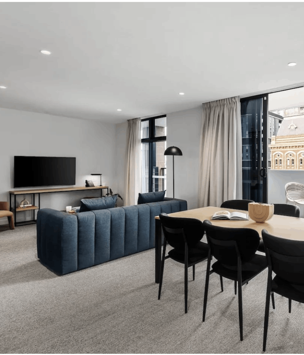 Living room with dining table and blue couch